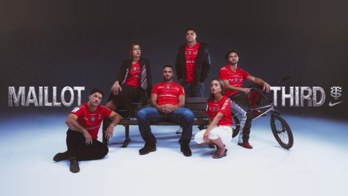 Joueurs du Stade Toulousain et jeunes Toulousains posant autour d'un banc public avec le maillot third rouge 2026-2027